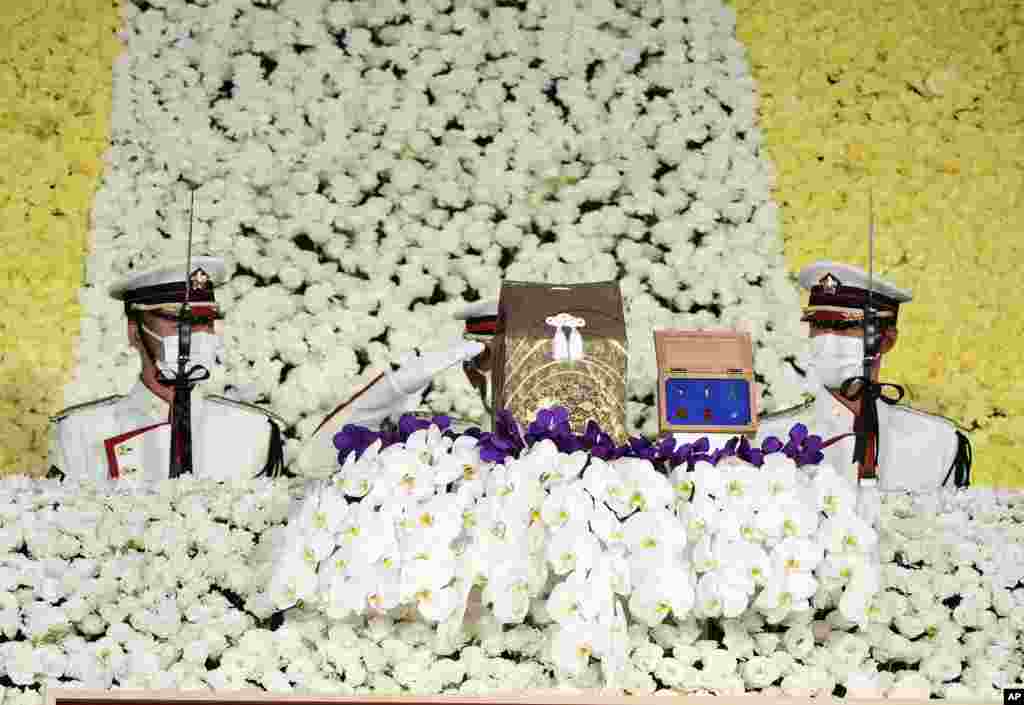 Honor guards salute a cinerary urn containing former Prime Minister Shinzo Abe's ashes during his state funeral in Tokyo, Japan.