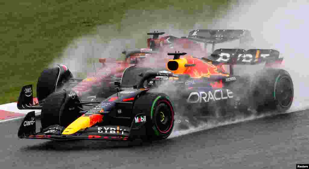 Ferrari's Charles Leclerc and Red Bull's Max Verstappen drive side by side after the start of the Formula One Japanese Grand Prix at Suzuka Circuit in Suzuka, Japan.