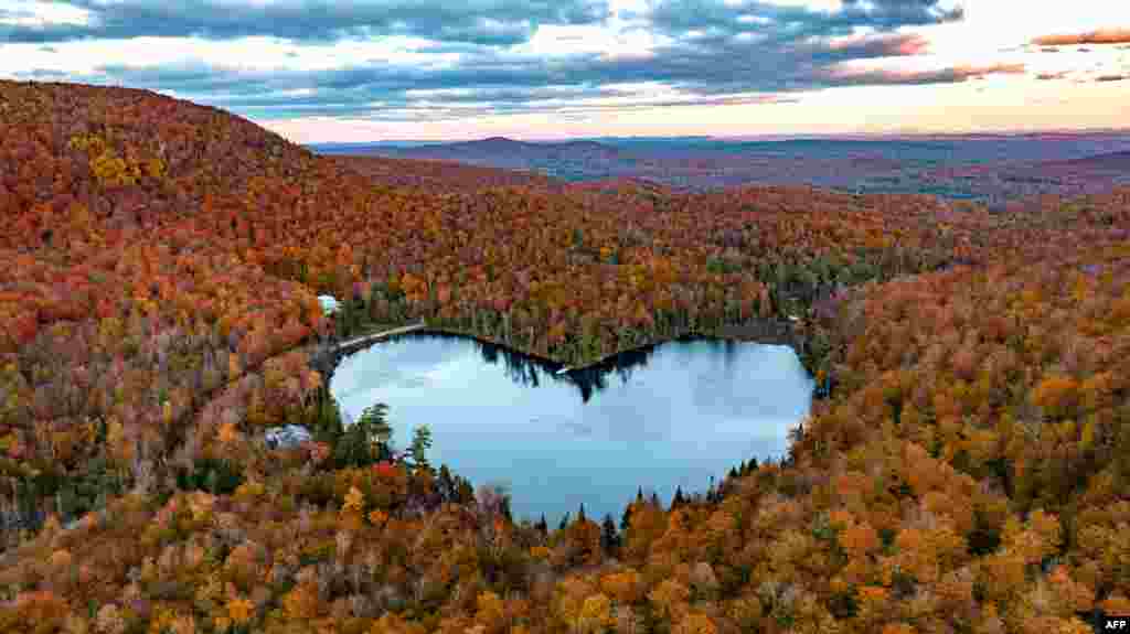 In this aerial image, Baker Lake near East Bolton, Quebec, Canada, is surrounded by fall colors.