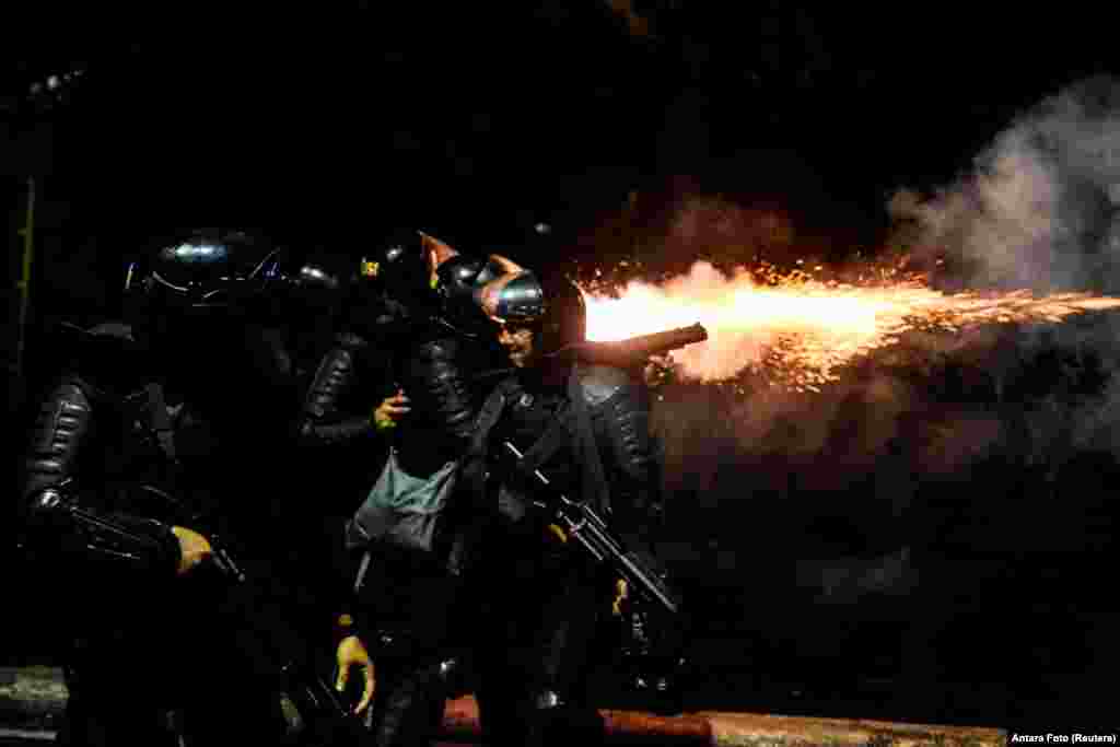 Police fire tear gas at protesters in Tanah Abang, Jakarta, Indonesia.