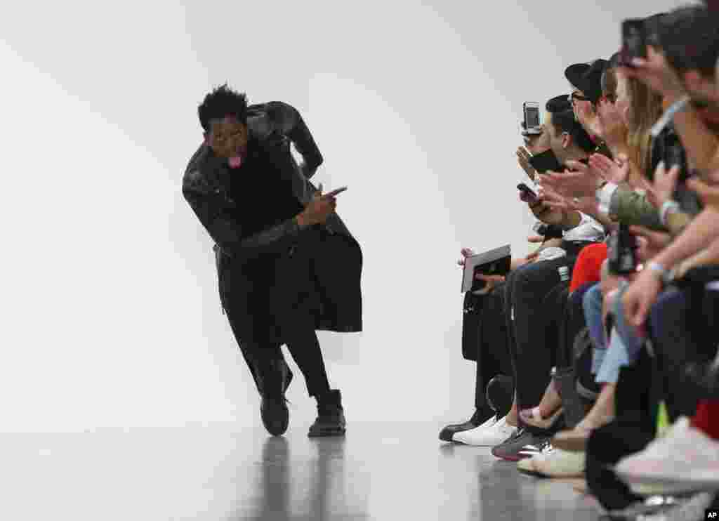 British fashion designer Nasir Mazhar takes the applause following London Men's spring summer fashion collections 2015, at Victoria House.