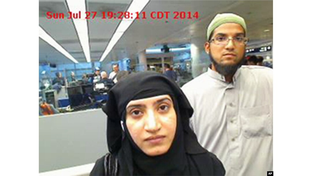 This July 27, 2014 photo provided by U.S. Customs and Border Protection shows Tashfeen Malik, left, and Syed Farook, as they passed through O'Hare International Airport in Chicago.