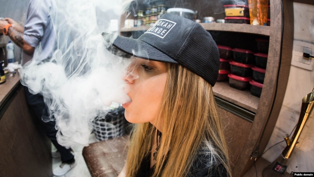 young woman vaping e-cigarette