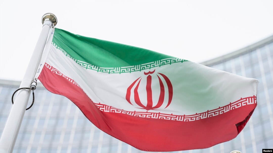 FILE - The flag of Iran waves in front of the the International Center building with the headquarters of the International Atomic Energy Agency, IAEA, in Vienna, May 24, 2021.