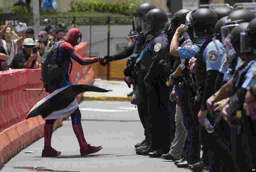 A protester dressed as Spiderman exercises civil disobedience when crossing the perimeter established by the police during a protest against the Federal Fiscal Control Board, as part of the May Day celebration, in San Juan, Puerto Rico, May 1, 2019.