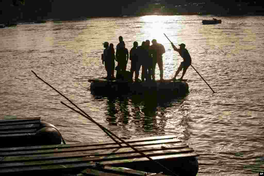 People across the Suchiate River between Tecun Uman, Guatemala, right, and Ciudad Hidalgo, Mexico, on a raft. Mexico's President Andrés Manuel López Obrador says tightening of immigration controls has focused "more than anything" on regulating entries at its southern border.