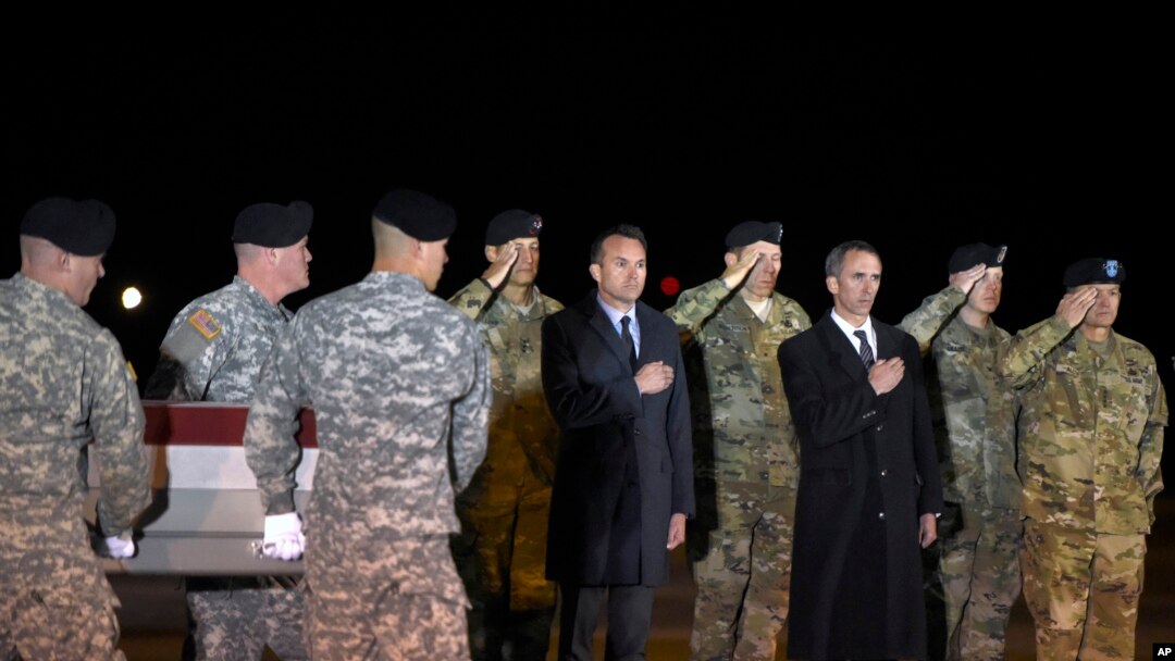 In this Monday, Nov. 7, 2016 file photo, an Army carry team moves a transfer case containing the remains of Staff Sgt. James Moriarty, past Army Secretary Eric Fanning, center, Undersecretary of Defense for Intelligence Marcel Lettre, third from right, and Gen. Daniel B. Allyn, right, Army vice chief of staff, at Dover Air Force Base, Del. According to the Department of Defense, Moriarty, 27, of Kerrville, Texas, died of wounds sustained on Nov. 4, in Jordan.