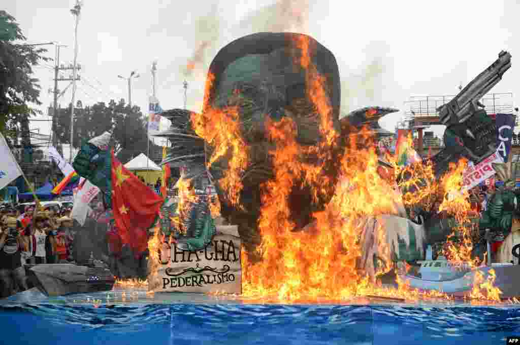 Activists burn an effigy of Philippine President Rodrigo Duterte depicted as a sea monster, during a protest near congress to coincide with Duterte's state of the nation address in Manila.