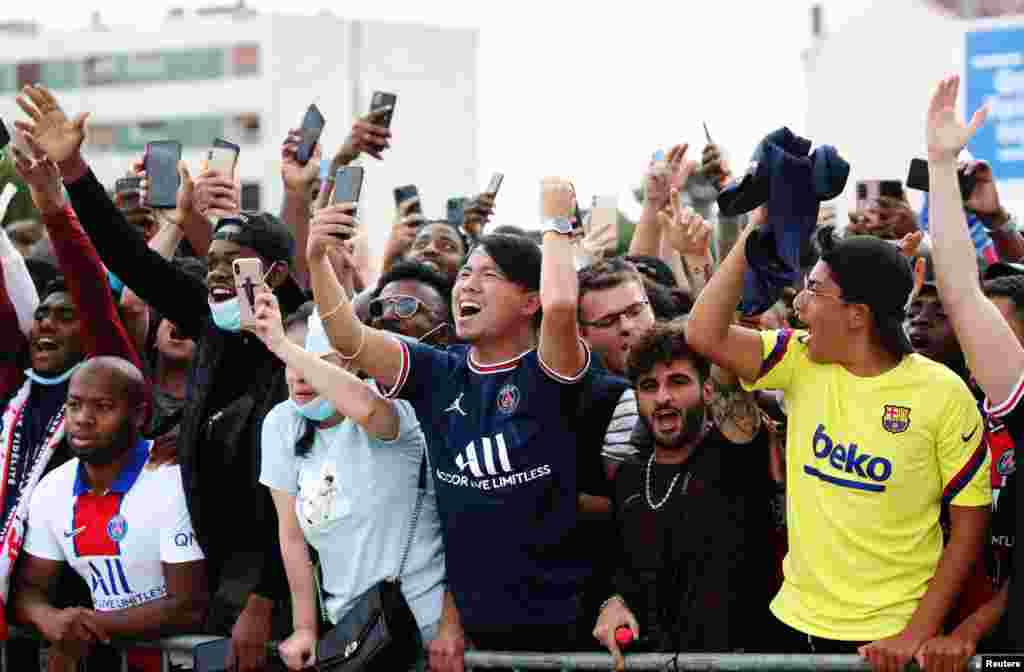 Fans await the arrival of Lionel Messi outside the Parc des Princes, France. The six-time Ballon d'Or winner received a hero's welcome to join Paris Saint Germain (PSG) following his shock departure from Barcelona.