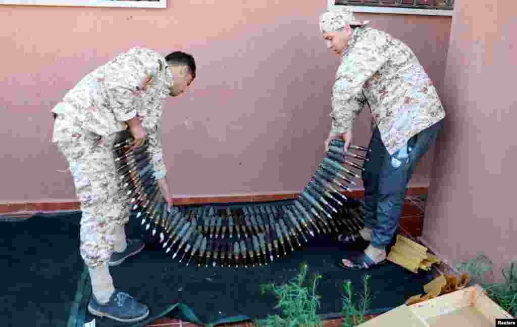 Members of the Misrata forces, under the protection of Tripoli's forces, prepare to go to the front line in Tripoli, Libya.