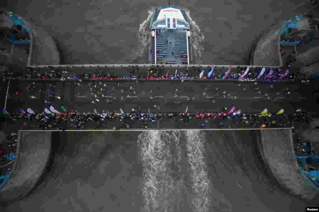 A boat passes under Tower Bridge during the London marathon.