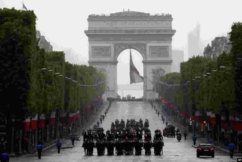 French President Emmanuel Macron's convoy drives up the Champs Elysees avenue to mark Victory Day at the Arc de Triomphe in Paris.