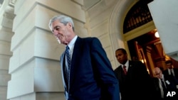 FILE - Former FBI Director Robert Mueller, the special counsel probing Russian interference in the 2016 election, departs Capitol Hill following a closed door meeting in Washington, June 21, 2017. 