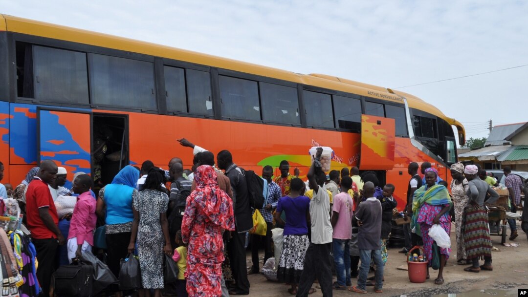 FILE - People board a commercial bus to flee following attacks by Boko haram in Bama and other parts of Maiduguri, Nigeria, Sept. 8, 2014. 