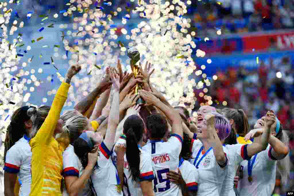 USA's players celebrate with the trophy after the France 2019 Women’s World Cup football final match between USA and the Netherlands, July 7, 2019, at the Lyon Stadium in Lyon, central-eastern France.