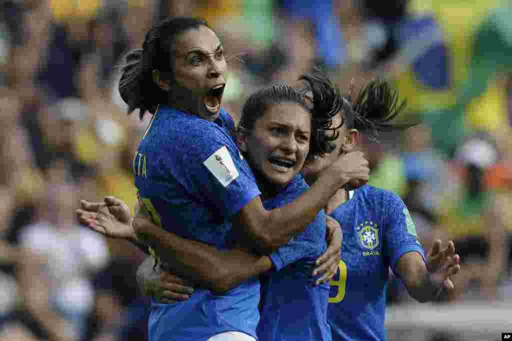 Brazil's Marta, left, celebrates with teammates after scoring the opening goal during the Women's World Cup Group C soccer match between Australia and Brazil at Stade de la Mosson in Montpellier, France.