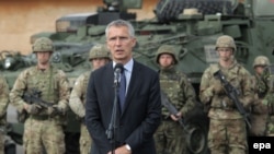 POLAND -- NATO Secretary-General Jens Stoltenberg delivers a statement after a meeting with soldiers of the Batallion Battle Group NATO near Orzysz, August 2017.