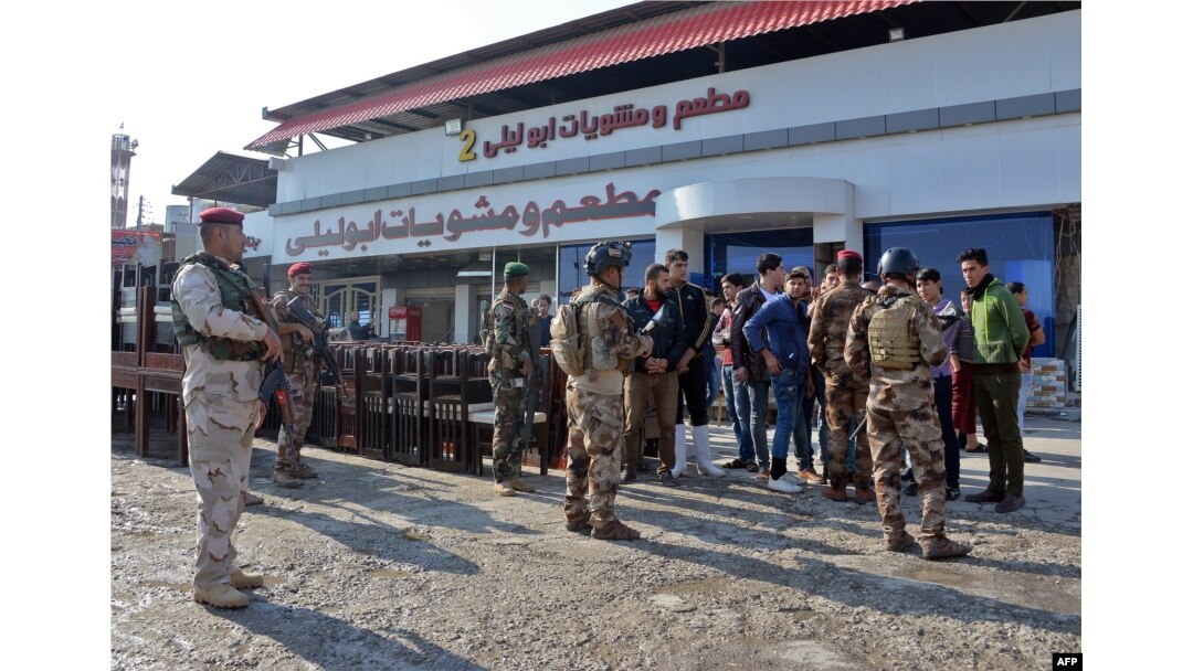 Iraqi security forces inspect the scene of a car bomb explosion the previous night in Mosul, Iraq, Nov. 9, 2018.