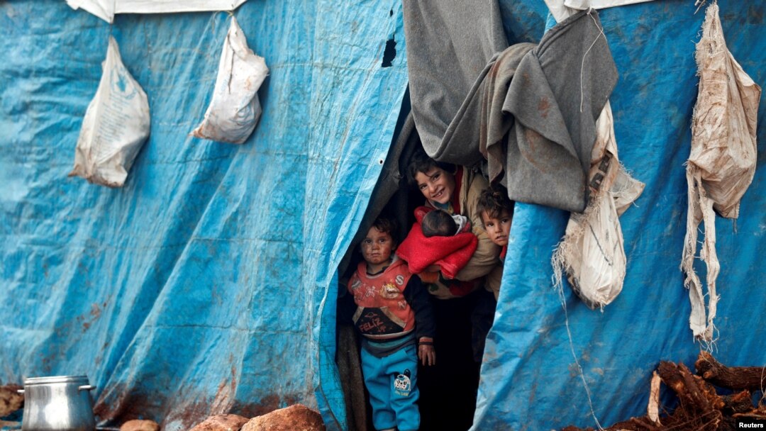 Displaced Syrian children look out from their tents at Kelbit refugee camp, near the Syrian-Turkish border, in Idlib province, Syria, Jan. 17, 2018.