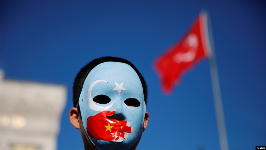 FILE - An ethnic Uighur boy wears a mask during a protest against China in Istanbul, Turkey, Dec. 14, 2019. 