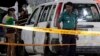 Members of Bangladeshi police and detective branch stand by the site where Italian citizen Cesare Tavella was gunned down by unidentified assailants in Dhaka, Sept. 29, 2015.