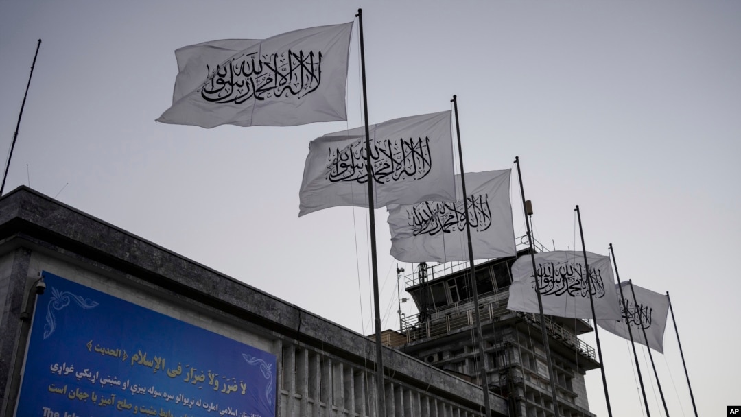 FILE - Taliban flags fly at the airport in Kabul, Afghanistan, on Sept. 9, 2021. 