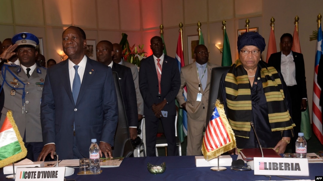 Ivory Coast's president Alassane Ouattara (L) and Liberia's president Ellen Johnson Sirleaf look on during the 49th summit of the Economic Community of West African States (ECOWAS) in Dakar, Senegal, June 4, 2016. 