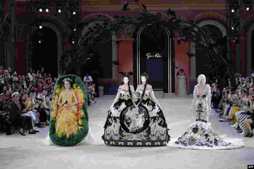 Models present creations by Guo Pei at the end of the Women's Fall-Winter 2019/2020 Haute Couture collection fashion show in Paris, France, July 3, 2019.