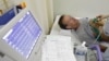 FILE - A stroke patient undergoes an electrocardiogram while recovering at Juntendo University Hospital in Tokyo. 