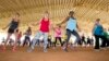FILE - Fitness enthusiasts run through dance exercises as they work out at Tropical Park in Miami, Florida, July 25, 2015.