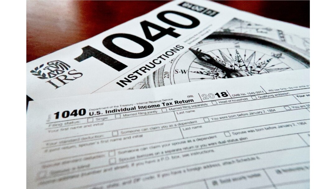 FILE - Forms printed from the Internal Revenue Service website that are used for 2018 U.S. federal tax returns are seen in Zelienople, Pennsylvania, Feb. 13, 2019.