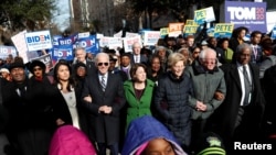 FILE - Democratic presidential rivals Tulsi Gabbard, Joe Biden, Amy Klobuchar, Elizabeth Warren and Bernie Sanders link arms during a Martin Luther King Jr. Day march, Jan. 20, 2020, in Columbia, South Carolina.