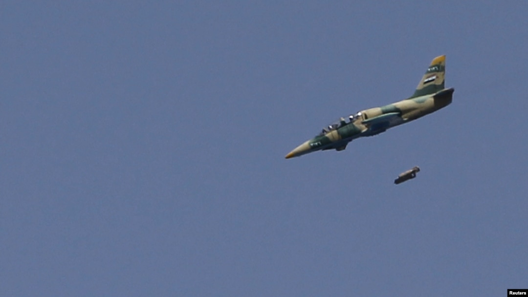 A Syrian Air Force fighter jet launches missiles at El Edaa district in Syria's northwestern city of Aleppo, September 1, 2012.