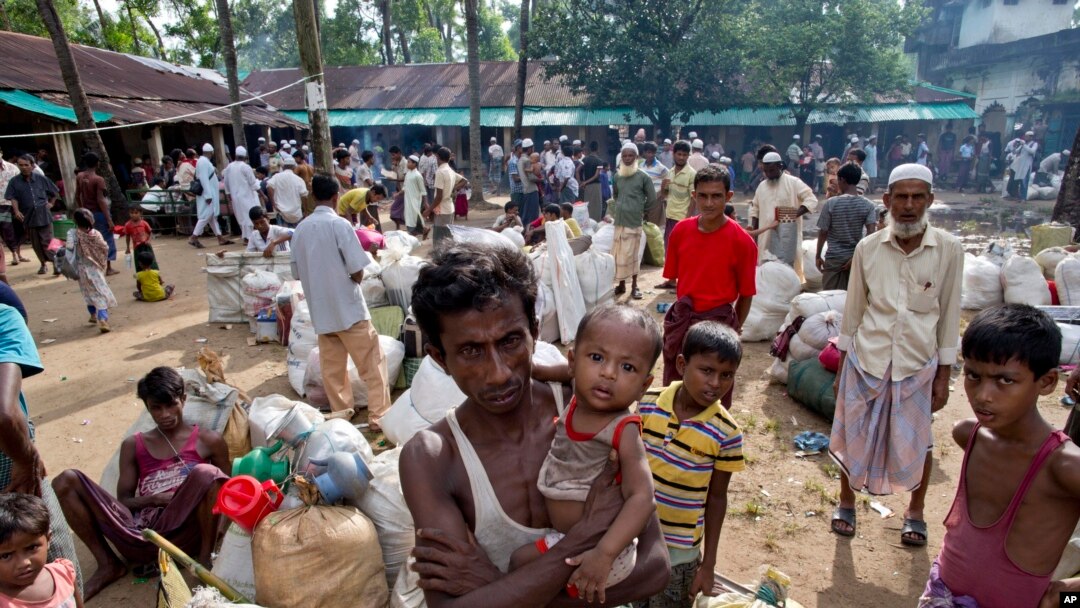 Newly arrived Rohingya Muslims from Myanmar prepare to leave a madrasa that they used as a transit shelter in Shahparirdwip, Bangladesh, Monday, Oct. 2, 2017.