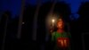 FILE - A Bangladeshi activist holds a candle, as they protest against the killing of secular blogger Niladri Chottopadhay Niloy in Dhaka, Bangladesh, Friday, Aug. 14, 2015.