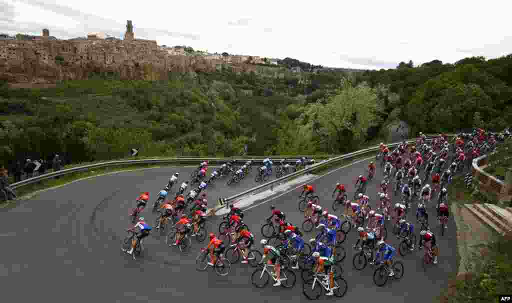 The peloton rides past Pitigliano during the stage four of the 102nd Tour of Italy cycle race, 235kms from Orbetello to Frascati.