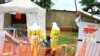 FILE - Health workers walk with a boy suspected of having been infected with the Ebola virus, at an Ebola treatment center in Beni, near Congo's border with Uganda, Sept. 9, 2018.
