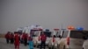 A convoy prepares to take at least 35 injured people from the war zone, Oct. 19, 2019. Five patients died before they were rescued on the outskirts of Ras al-Ayn, Syria. (Yan Boechat/VOA)