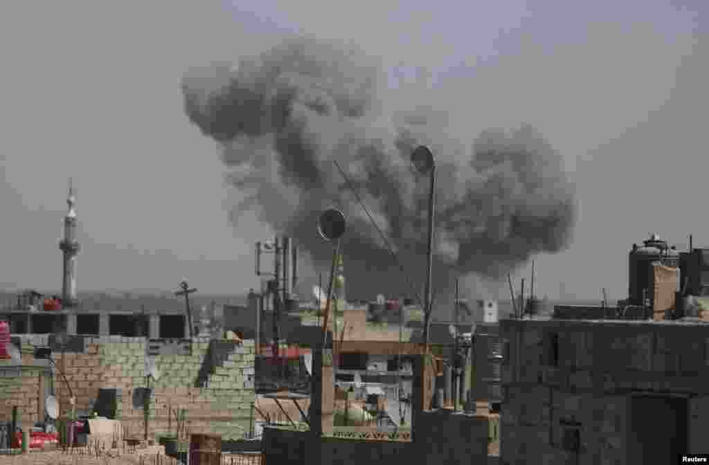 Smoke rises after what activists said was an air strike by forces loyal to Syria's President Bashar al-Assad on the outskirts of the Duma neighborhood of Damascus.