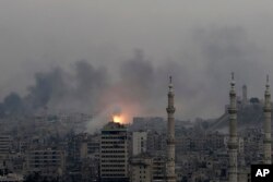 A ball of fire rises following a Syrian government airstrike that hit rebel positions in the eastern neighborhoods of Aleppo, Dec. 5, 2016.
