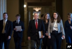 Senate Majority Leader Mitch McConnell, R-Ky., walks to the chamber on the first morning of a government shutdown after a divided Senate rejected a funding measure last night, at the Capitol in Washington, Jan. 20, 2018.