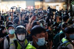 HONG KONG -- Journalist cover a march against national security law at the anniversary of Hong Kong's handover to China from Britain, in Hong Kong, China July 1, 2020.