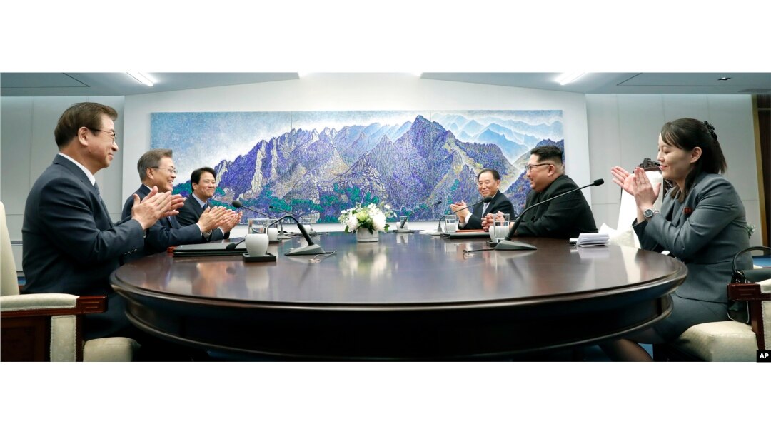 North Korean leader Kim Jong Un (2nd-R) talks with South Korean President Moon Jae-in (2nd-L) during a meeting at the border village of Panmunjom in Demilitarized Zone, April 27, 2018.