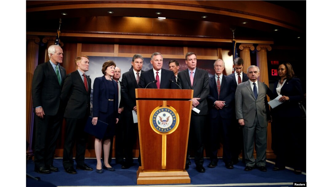 Chairman of the Senate Intelligence Committee Richard Burr (R-NC) stands with members of the committee as he speaks to the media about the committee's findings and recommendations on threats to election infrastructure on Capitol Hill in Washington, March 20, 2018.