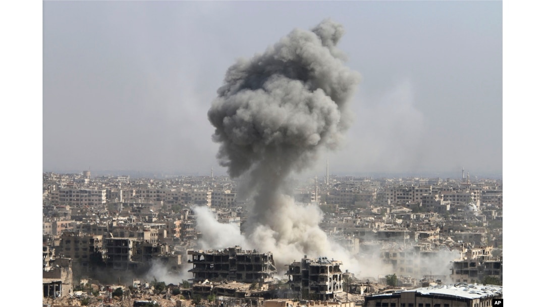 FILE - Smoke rises after shelling by the Syrian army, after Russian airstrikes, in Damascus, Syria, Oct. 14, 2015.