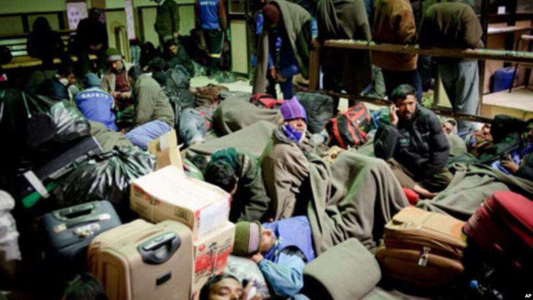 People wait at the Egyptian border after fleeing Libya. The number still stuck there has dropped a lot.