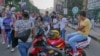 FILE - A group of young men make loud jokes while three girls walk by them in Cairo, Egypt, June 15, 2018. (Hamada Elrasam/VOA) 