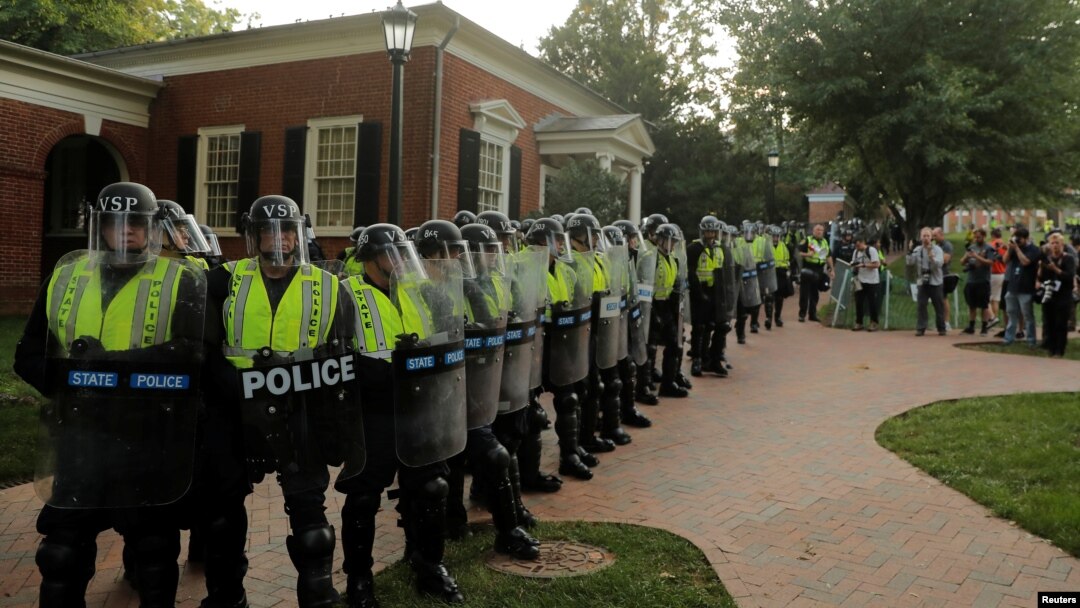 Virginia State Police officers form a cordon at the University of Virginia ahead of the one year anniversary of the 2017 Charlottesville "Unite the Right" protests, in Charlottesville, Va., Aug. 11, 2018.
