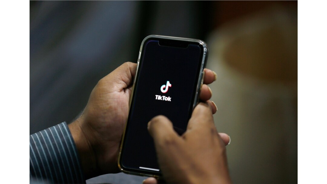 FILE - A man opens social media app TikTok on his cellphone, in Islamabad, Pakistan, July 21, 2020.