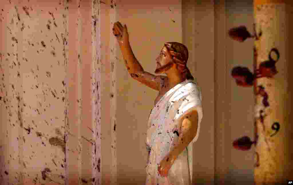 Blood stains are seen on the wall and on a Jesus Christ statue at the St. Sebastian's Church after blast in Negombo, north of Colombo, Sri Lanka. More than 200 people were killed and hundreds more injured in eight blasts that rocked churches and hotels in and just outside the capital on Easter Sunday.